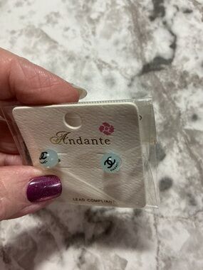 Andante Stud Earrings with Black Logo on Pale Blue Discs